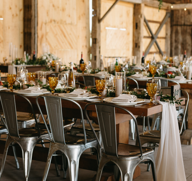 A charming wedding venue featuring a rustic wood interior, with beautifully crafted wood tables adding warmth and natural elegance to the space