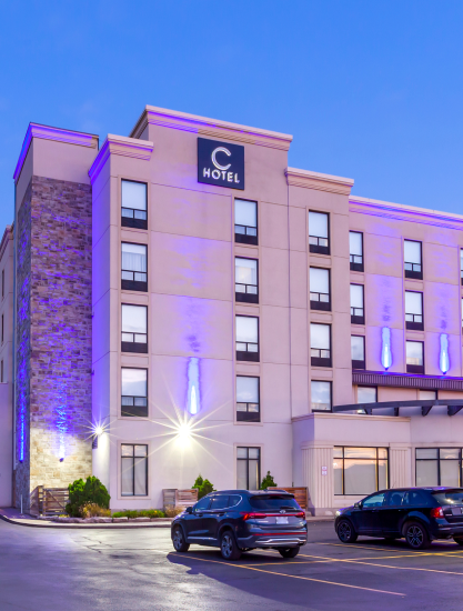 The exterior of C Hotel illuminated with captivating purplish blue lighting
