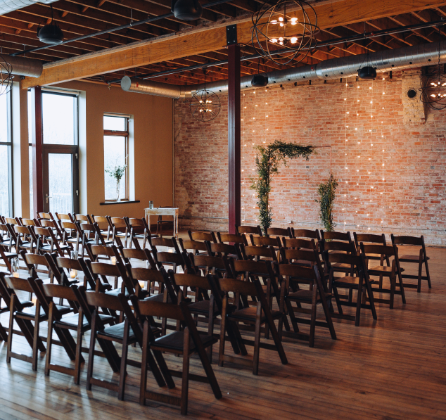 Rows of empty chairs in a spacious event hall at River's Edge