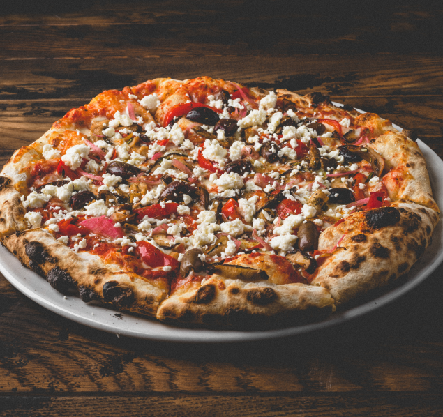 A delicious pizza topped with crumbled feta cheese and sliced black olives